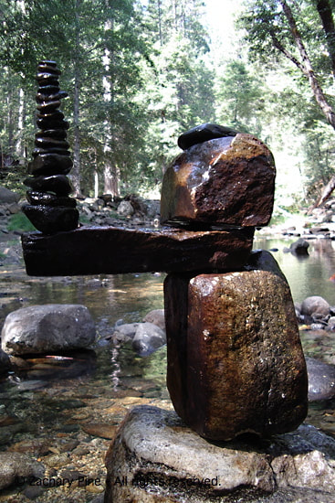 Afternoon, North Fork of the Tuolumne River, California. Rocks. I take all these rocks wet from the river. When I am finished building, some of them have dried in the sun. I scoop river water in my hands and drip the rocks to make them all wet. The force of dripping water makes the piece wiggle. The force of running water has made these rocks what they are. 2004.
