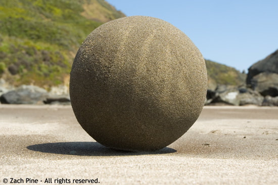 Afternoon, Stinson Beach, California. Sand ball resting on wind-smoothed sand. The west side of my face is warm. 2007.