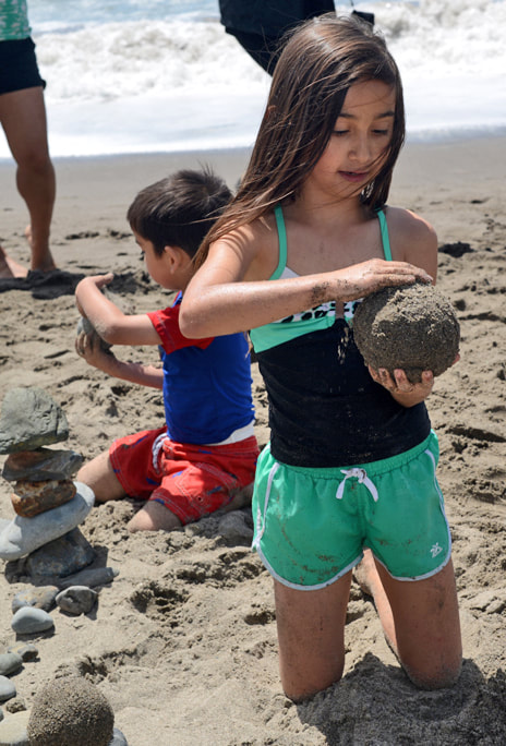 Children making sand globes